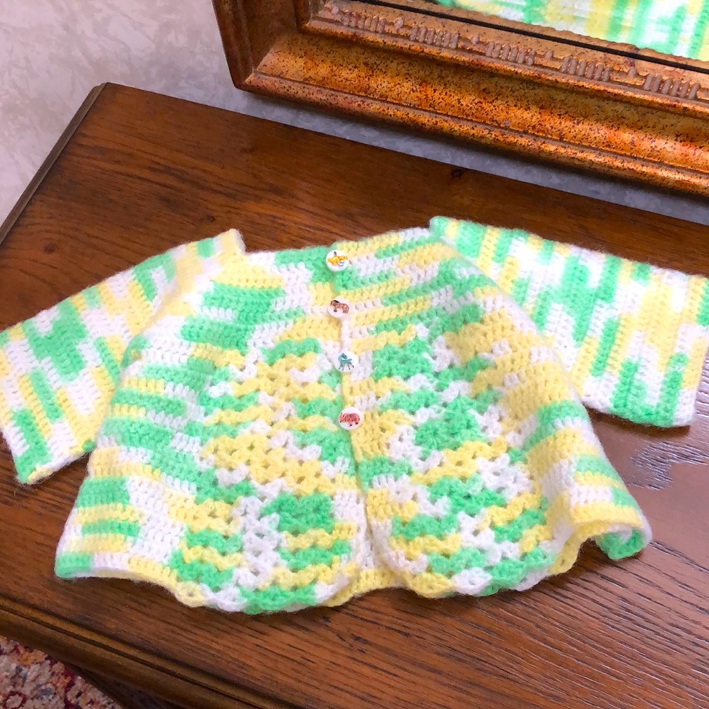 New Infant hand crocheted sweater.  Cute animal buttons.